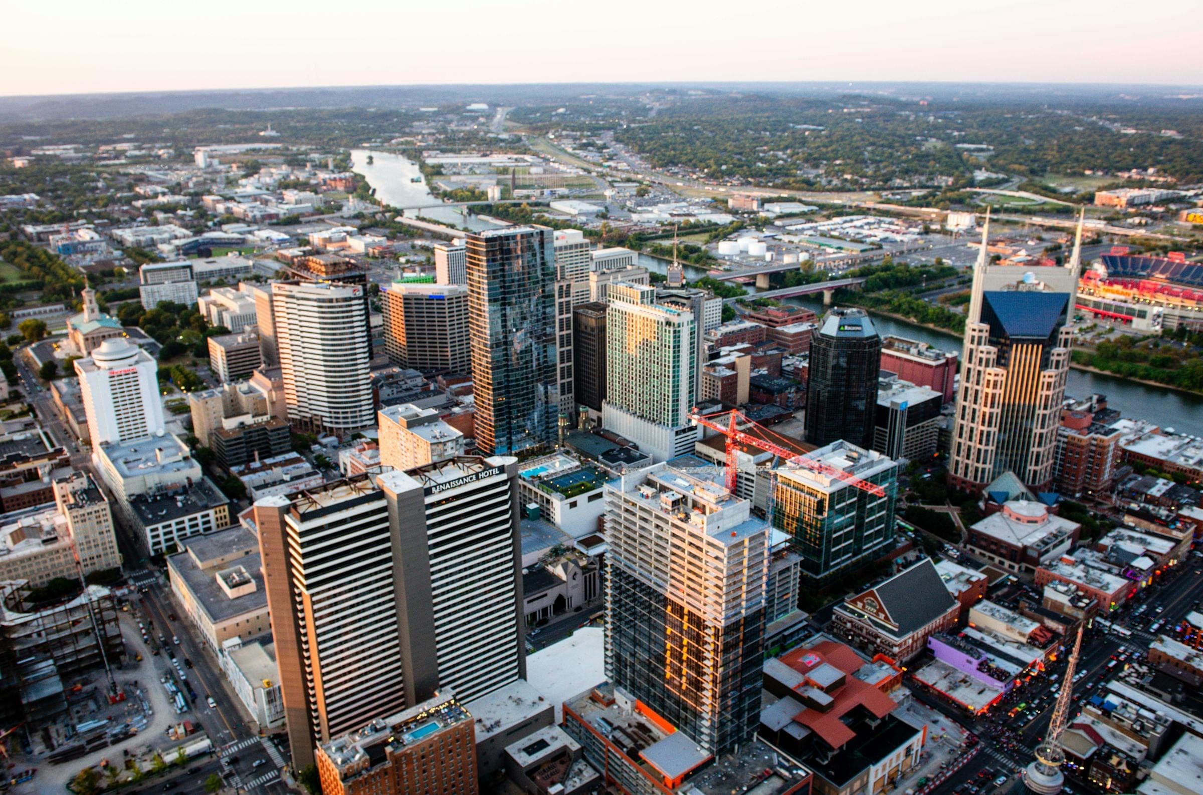 Aerial sunset view across downtown Nashville with the Cumberland River winding through Middle Tennessee