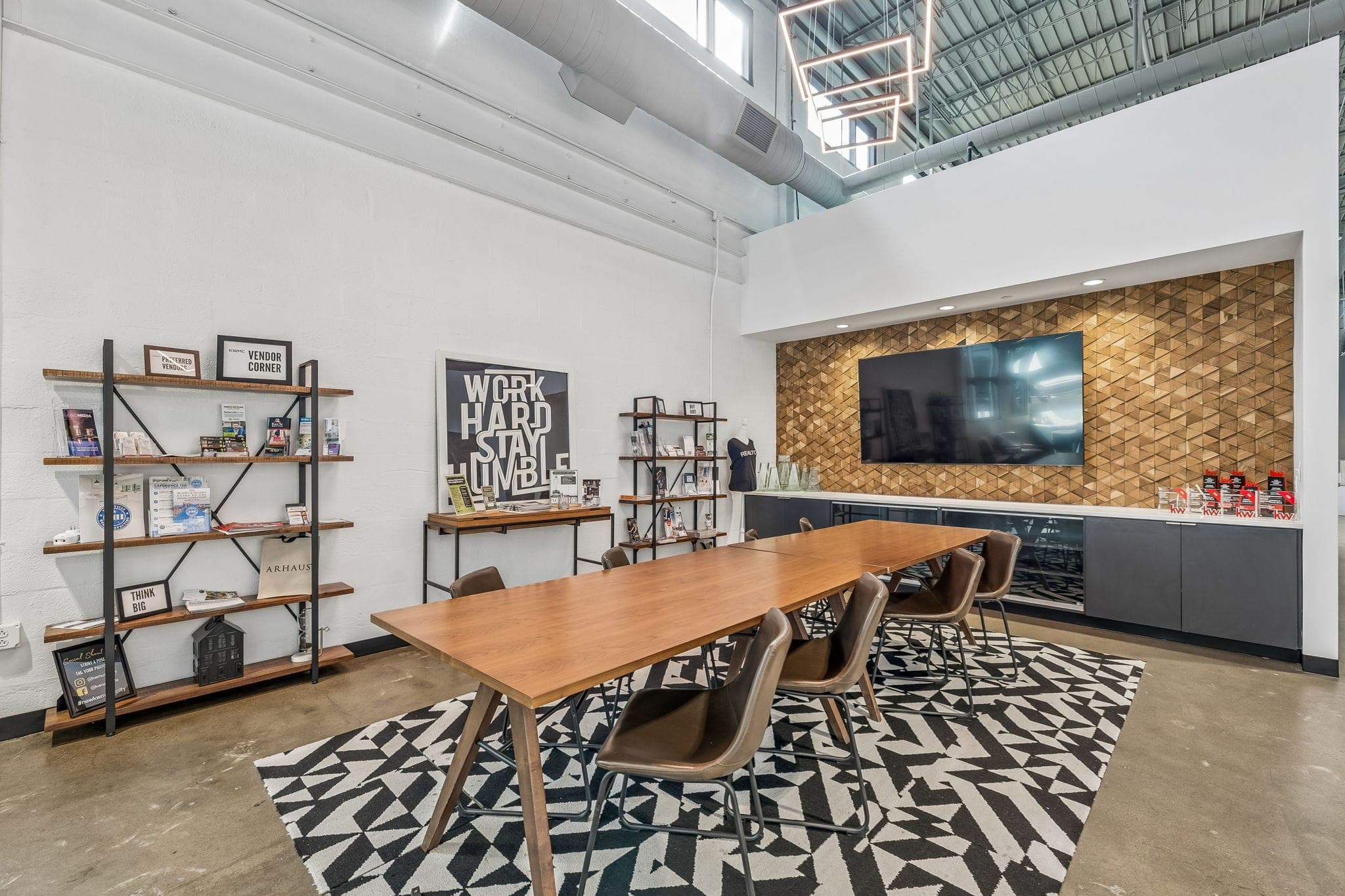 Communal work table and partner-resource shelving in the open workspace of the Nashville office