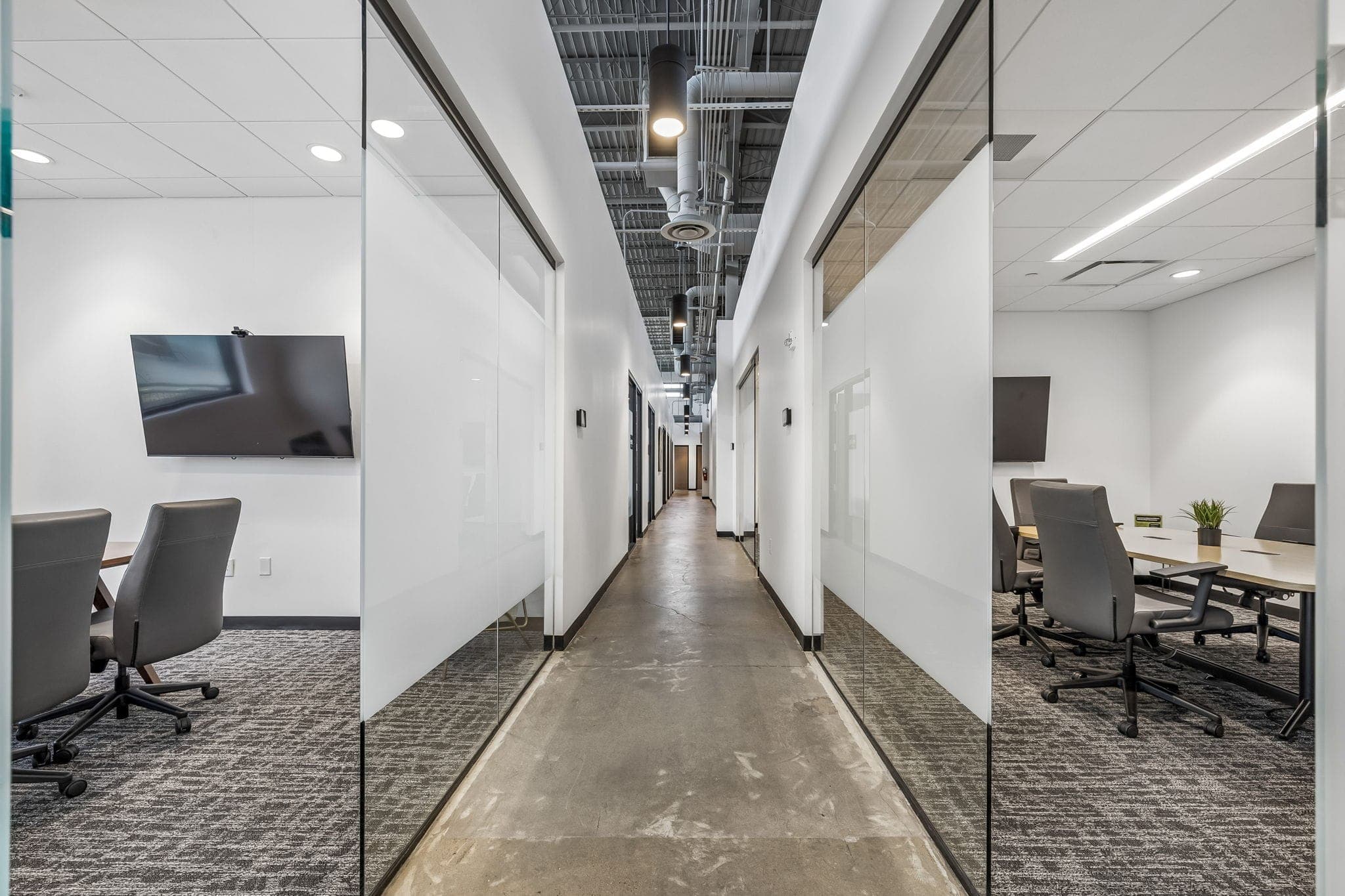 Polished corridor between glass-walled conference rooms at the Nashville Music City office