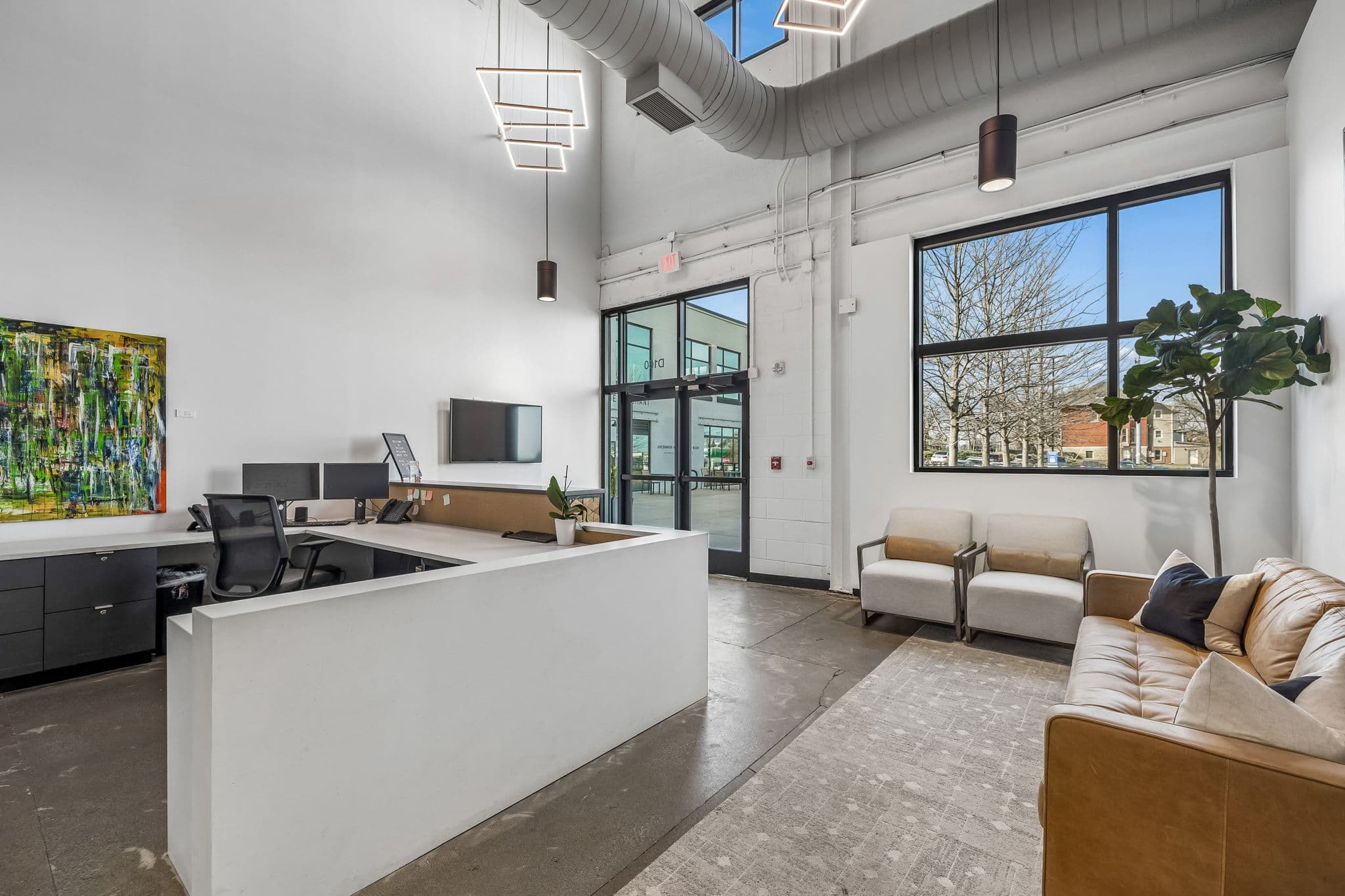 Reserved partner workstation bathed in afternoon light at KW Nashville Music City — strategic alliance environment for aligned professionals